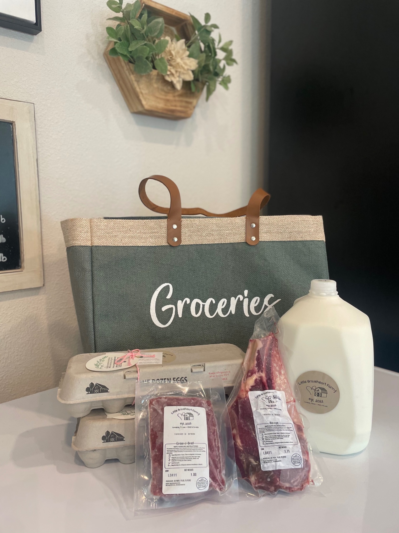 A Little Braveheart Farms grocery haul — a gallon of fresh milk, farm eggs, and packaged beef cuts